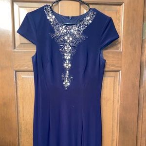 Floor length navy bedazzled dress.